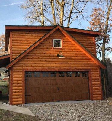 Beautiful wood grain door installed on this log cabin garage.