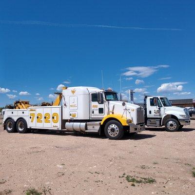 One of our big wreckers with our elevation, 7220, printed on the side. A flatbed truck is behind it.