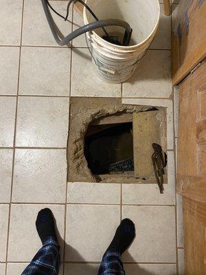 Above view of broken basement floor needing additional work to install a sump pump