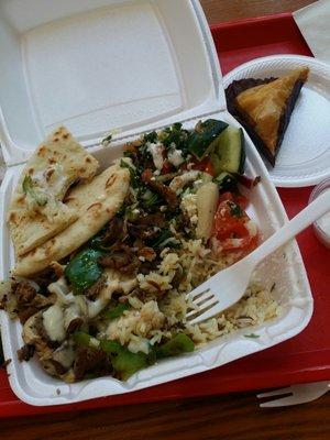 Chicken/lamb plate with melted swiss on top and feta and sides of tabbouleh and cucumber salad.