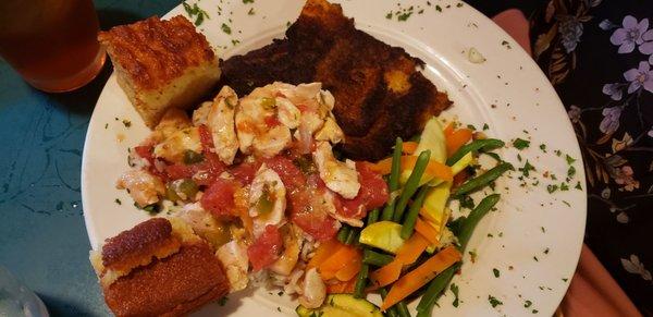 Blackened fish with chicken jambalaya over rice with vegetables and corn bread.