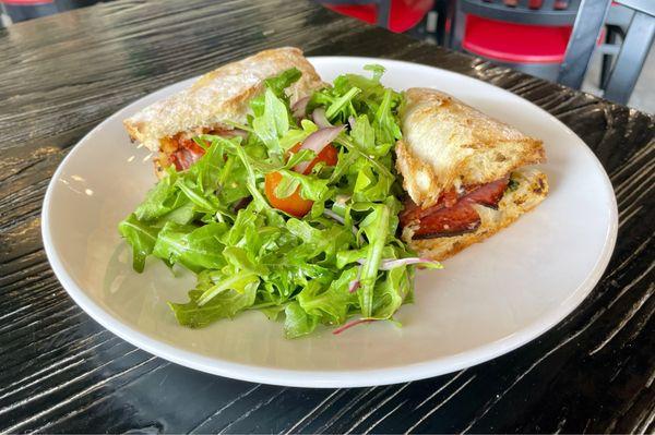 Italian hoagie with an arugula salad