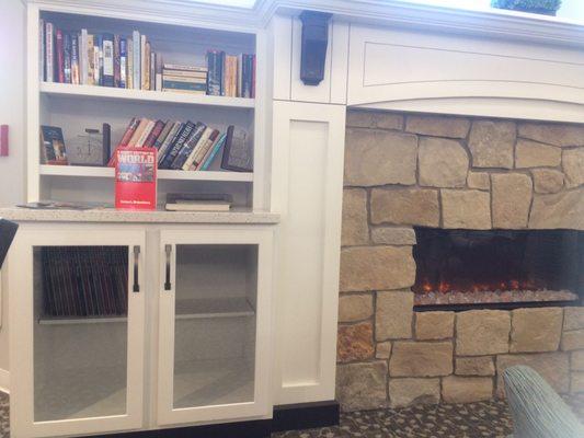 Bookshelves on the one side. Grab a book and drink your coffee or other beverage. Leave and Take Lending Library type set-up.