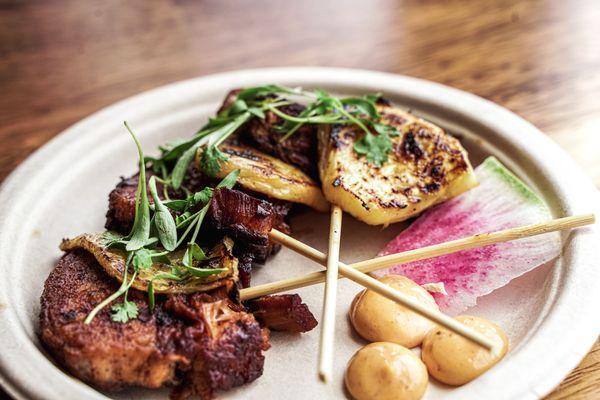 Pork belly skewers with pineapple and chipotle aioli.