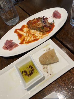 Eggplant Parmesan appetizer, and table bread (olive oil with olives)