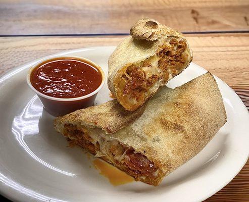 Chicken Parm Stromboli Roll served with a side of house marinara