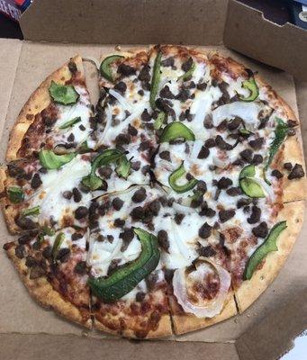 A Small Pizza with Ground Beef, Green Pepper, and Onions