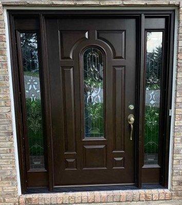 traditional entry door with decorative glass insert and sidelights