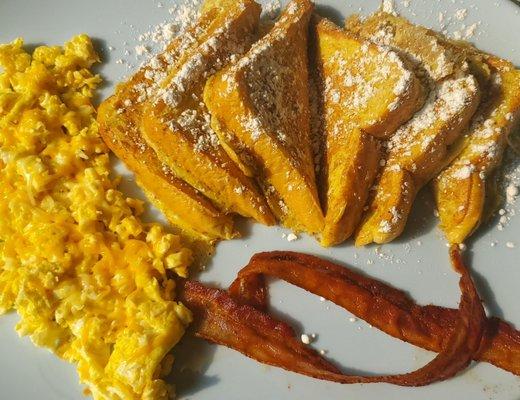 French toast plate with bacon and scrambled eggs.