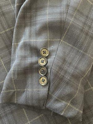 The bunching is so bad the sleeve won't lay down.  Buttons too close and crooked.