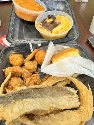 Mac and cheese and candies yams with corn bread, whitening fish, fried shrimp, and hush puppies.