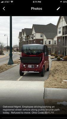 Again! Oakwood Mgmt. Employee driving/parking a registered street vehicle blocking public bicycle path. Refused to move. ORC 4511.711 & .713