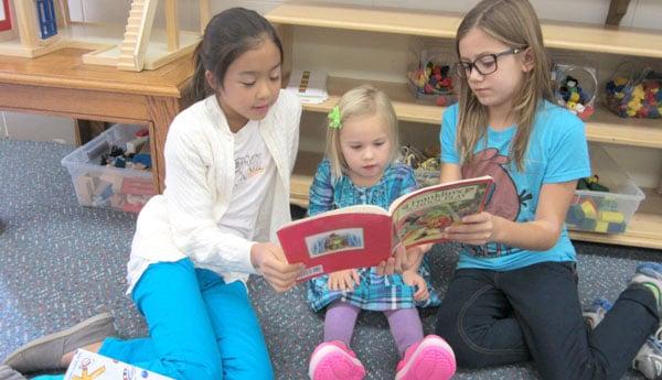 Younger students are paired with an older student to be "reading buddies."