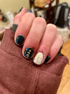 Festive holiday nails with nail design on middle (Christmas tree) and ring finger (present)