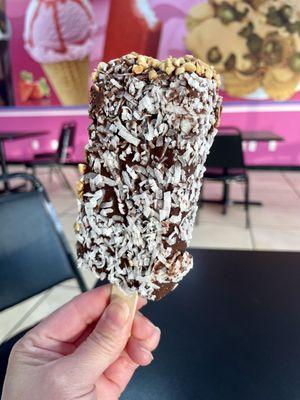 Coconut ice cream, dipped in chocolate, nuts opposite side. 6/9/22