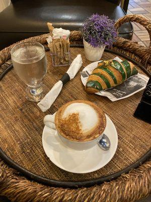 Regular milk capuccino and pistachio croissant.