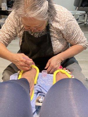 The final "touch up" of the most AMAZING pedicure!!