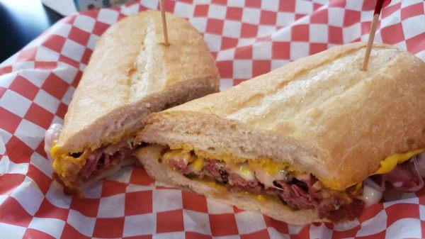 Tasty hot pastrami sandwich .