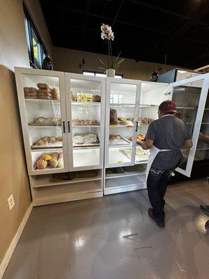 Fresh bread being loaded into bread case