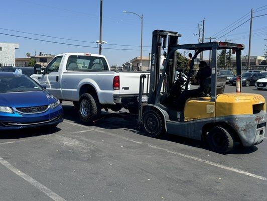 My poor truck being brought out of the tow yard