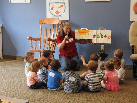 The 1's class being read The Hungry Caterpillar by Miss Samantha