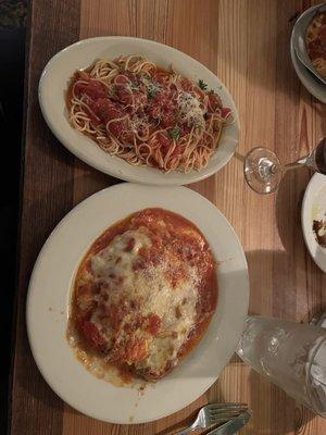 Chicken Parmigiana in Fra Diavolo sauce with spaghetti and marinara sauce.