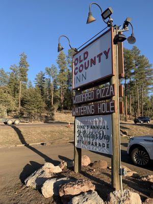 Restaurant sign near road.