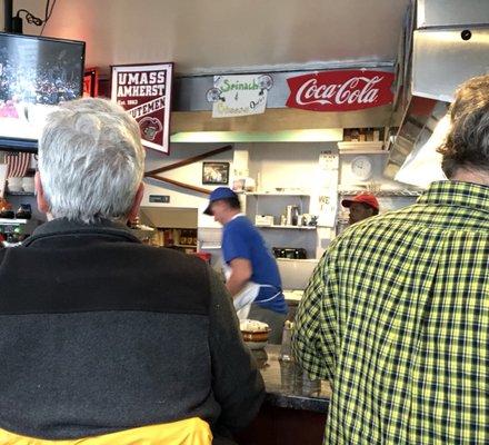 Counter seating overlooks cooks and sports-on-TV in this small but well-attended diner.