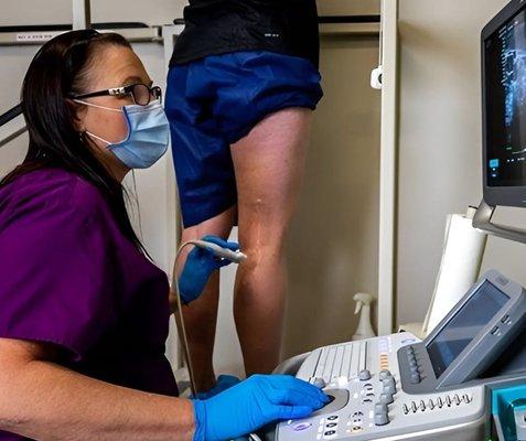 USA Vein Clinic doctor looking at legs