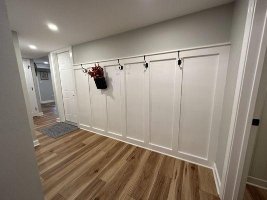 Foyer wainscoting with new flooring and lighting