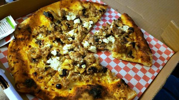 La Bianca Pizza - Sausage, Mushrooms, Goat Cheese and Chili Flakes on a white sauce pizza.