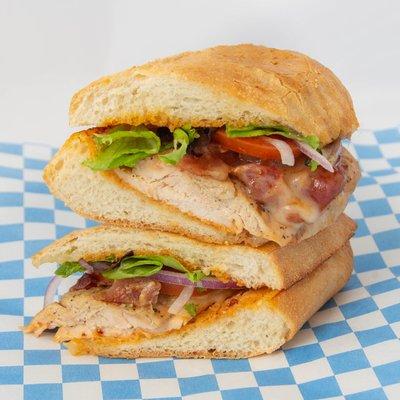 Chicken Chipotle - Sous Vide chicken breast, Swiss, bacon, greens, tomato, onion, chipotle mayo on a toasted French roll w/house side