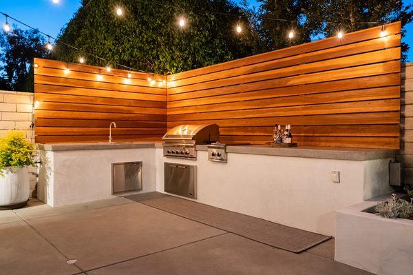 Custom built outdoor kitchen with accent wall