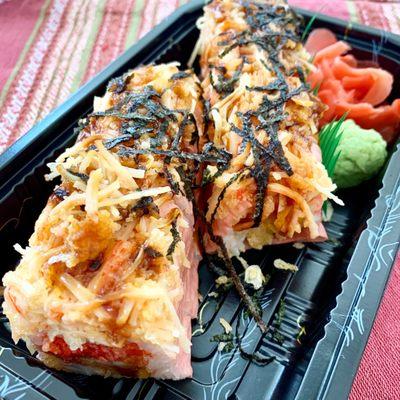 Masa Roll: Shrimp tempura, spicy tuna & mango wrapped w. soy paper top w. spicy crab and seaweed