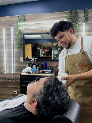 A tranquil moment under the barber's skilled hands, where every shave and trim becomes a relaxing ritual.