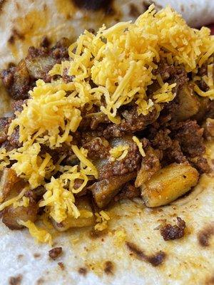 Potato & chorizo Tacos ( added Shredded Cheese )