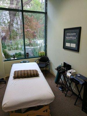 Acupuncture, soft tissue, cupping, and class IV deep tissue therapy laser treatment room.