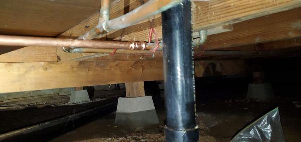 Copper pipe leak repaired in a crawlspace