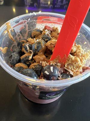 Açaí bowl with blueberries, cinnamon granola, coconut, goji berries, and almond butter.