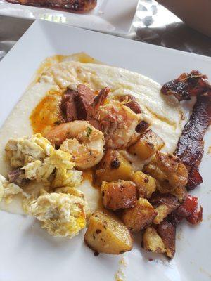 Creamy grits Sauteed potatoes  Spiced brown sugar bacon Scramble eggs Shrimp and sausage in creole sauce