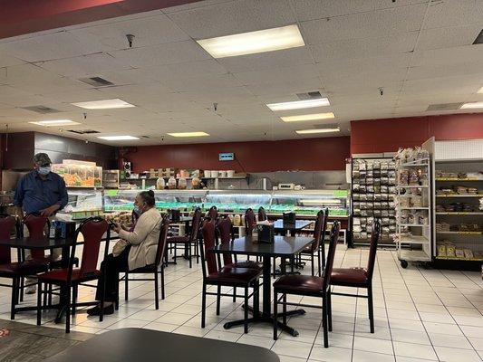 Eating area with butcher counter in back. Door to outside is behind the big pig head in the glass box. "Hi flies! Come on in!"...........:::