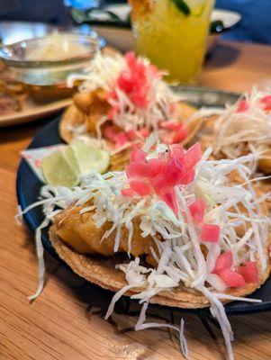 Los Tacos Baja Fish. $14. Tempura cod, pickled red onions, shaved cabbage, Morita Mayo.