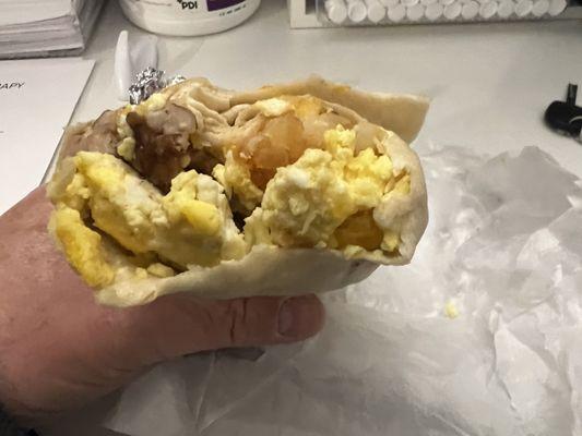 Sausage, egg and potato breakfast burrito.