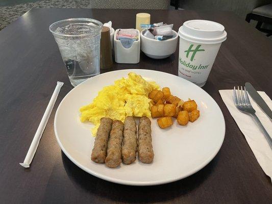 Scrambled eggs, potatoes, and sausage from the breakfast buffet.