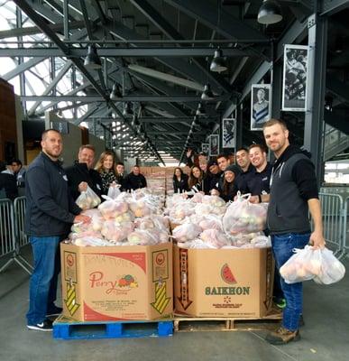 The ERG team volunteering at Avaya Stadium packing food for Thanksgiving.