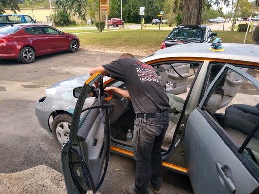 Tim taping up vehicle for paint.