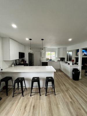 Recessed can lighting and island pendant light installation at this property