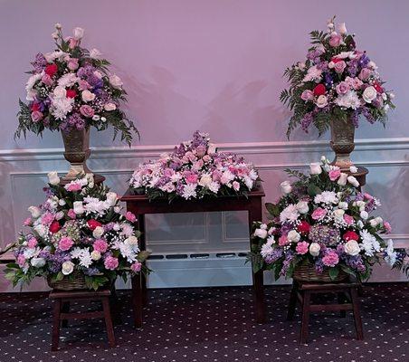 Urn wreath, two vase and two basket arrangements.