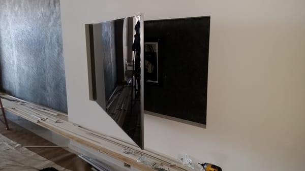 Flush mounted recessed TV on an articulating arm.