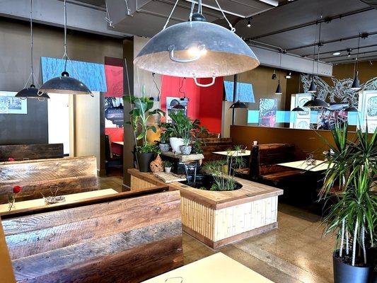 Dining Area with Water Feature and Repurposed Woks as Lights